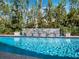 Sparkling swimming pool with a modern water feature, complemented by lush landscaping for a private outdoor oasis at 3322 Bayou Rd, Longboat Key, FL 34228
