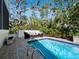 Tranquil backyard pool with seating area surrounded by lush greenery at 3322 Bayou Rd, Longboat Key, FL 34228