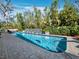 Tranquil swimming pool surrounded by tropical landscaping and a unique water feature wall for serene outdoor enjoyment at 3322 Bayou Rd, Longboat Key, FL 34228