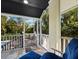 Relaxing screened porch with a dark wood ceiling and a comfortable lounge chair overlooking the pool at 3322 Bayou Rd, Longboat Key, FL 34228