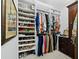 Organized walk-in closet featuring custom shelving for shoes and clothes and dark wood cabinetry at 3322 Bayou Rd, Longboat Key, FL 34228