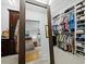 Spacious walk-in closet with custom shelves and cabinetry, view into bedroom at 3322 Bayou Rd, Longboat Key, FL 34228