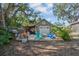 Backyard area featuring a charming outbuilding, fire pit, and seating area for relaxation and entertainment at 3526 Austin St, Sarasota, FL 34231