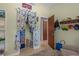 Cheerful bedroom showcasing playful curtains, a storage shelf, and an organized closet at 3526 Austin St, Sarasota, FL 34231