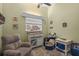Cozy bedroom with neutral paint, plush chair, and bright window for natural light at 3526 Austin St, Sarasota, FL 34231