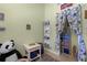 Bright bedroom featuring playful decor, a bookshelf, and a curtained play area at 3526 Austin St, Sarasota, FL 34231