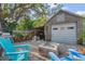 Charming outbuilding featuring a fire pit and comfortable seating area in a serene backyard setting at 3526 Austin St, Sarasota, FL 34231