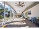 Expansive screened-in patio with brick flooring, ceiling fans, and ample seating arrangements at 3526 Austin St, Sarasota, FL 34231