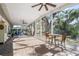 Relaxing screened-in patio with wicker furniture, high top table and well-manicured outdoor view at 3526 Austin St, Sarasota, FL 34231