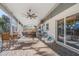 Spacious screened patio with comfortable seating areas, ceiling fans, and outdoor furniture at 3526 Austin St, Sarasota, FL 34231