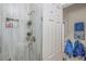 Bathroom featuring a tiled shower with glass doors, a showerhead, and a door at 3526 Austin St, Sarasota, FL 34231