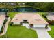 Aerial view of a single-story home featuring a pond, swimming pool, well-kept lawn, and beautiful landscaping at 3606 Garden Lakes Clenet, Bradenton, FL 34203