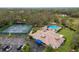 Aerial view of community amenities including a pool, tennis courts, parking, and clubhouse at 3606 Garden Lakes Clenet, Bradenton, FL 34203
