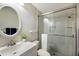 Well-lit bathroom featuring a sleek vanity with a modern faucet and a glass-enclosed shower at 3606 Garden Lakes Clenet, Bradenton, FL 34203