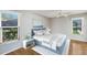 Bedroom with modern decor, wood floors, and natural light from two windows at 3606 Garden Lakes Clenet, Bradenton, FL 34203
