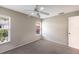 Cozy bedroom with neutral walls, plush carpet, and a ceiling fan for added comfort at 3606 Garden Lakes Clenet, Bradenton, FL 34203