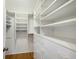 Large walk-in closet with custom shelving and drawers, offering ample storage space at 3606 Garden Lakes Clenet, Bradenton, FL 34203