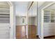 Spacious closet with built in shelving and a view into a bedroom with laminate floors and a ceiling fan at 3606 Garden Lakes Clenet, Bradenton, FL 34203