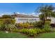 The Garden Lakes community sign is surrounded by colorful plants and manicured landscaping under a blue sky at 3606 Garden Lakes Clenet, Bradenton, FL 34203