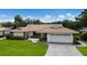 Charming single-story home with a well-maintained lawn, brick driveway, and two-car garage at 3606 Garden Lakes Clenet, Bradenton, FL 34203