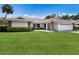 Charming single-story home with a lush green lawn, tile roof, and two car garage at 3606 Garden Lakes Clenet, Bradenton, FL 34203