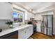 Modern kitchen features white cabinets, stainless steel appliances, hardwood floors and a window view at 3606 Garden Lakes Clenet, Bradenton, FL 34203