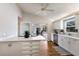Modern kitchen features white cabinets, stainless steel appliances, hardwood floors and a view to the patio at 3606 Garden Lakes Clenet, Bradenton, FL 34203