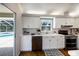 Contemporary kitchen boasts white cabinets, stainless steel appliances, with a pass-through to the patio at 3606 Garden Lakes Clenet, Bradenton, FL 34203