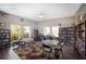 Inviting library with bookshelves, tables, chairs, and large windows at 3606 Garden Lakes Clenet, Bradenton, FL 34203
