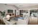 Bright living room with hardwood floors, sliding glass doors to patio, and neutral decor at 3606 Garden Lakes Clenet, Bradenton, FL 34203