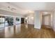 Inviting living room featuring wood-look floors and access to kitchen and outdoor living spaces at 3606 Garden Lakes Clenet, Bradenton, FL 34203