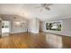 Bright living room boasts hardwood floors, neutral walls, and a contemporary ceiling fan and light fixture at 3606 Garden Lakes Clenet, Bradenton, FL 34203