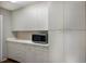 Large pantry featuring built-in storage, countertop space, and modern appliances for convenient organization at 3606 Garden Lakes Clenet, Bradenton, FL 34203