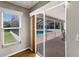 The view from this bedroom features a window and access to the screened-in lanai with pool at 3606 Garden Lakes Clenet, Bradenton, FL 34203