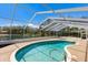 Sparkling pool enclosed in a screened lanai, providing privacy and a bug-free swimming experience at 3606 Garden Lakes Clenet, Bradenton, FL 34203