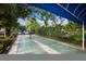 Shuffleboard courts surrounded by lush landscaping and shaded by a blue canopy at 3606 Garden Lakes Clenet, Bradenton, FL 34203
