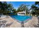 Outdoor community swimming pool surrounded by chairs and a brick patio at 3606 Garden Lakes Clenet, Bradenton, FL 34203