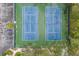Aerial view of well-maintained tennis courts, adjacent parking, surrounded by mature trees and landscaping at 3606 Garden Lakes Clenet, Bradenton, FL 34203