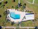 An aerial view of a large community pool with sundeck, lounge chairs, and manicured landscaping at 3626 Medford Ln # 1537, Sarasota, FL 34232
