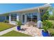 Charming back patio with brick pavers, outdoor seating, and lush landscaping at 3626 Medford Ln # 1537, Sarasota, FL 34232