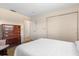 Neutral bedroom with carpet flooring, white bedspread, closet, and a chest of drawers at 3626 Medford Ln # 1537, Sarasota, FL 34232