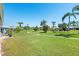Lush green community lawn with mature trees and walking path at 3626 Medford Ln # 1537, Sarasota, FL 34232