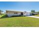 Quaint single-story home featuring a well-maintained lawn and an attached single-car garage at 3626 Medford Ln # 1537, Sarasota, FL 34232