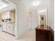 Hallway view shows access to the kitchen and other rooms with neutral color walls at 3626 Medford Ln # 1537, Sarasota, FL 34232