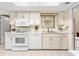 Practical kitchen featuring white cabinets, appliances, and ample counter space with a window view at 3626 Medford Ln # 1537, Sarasota, FL 34232