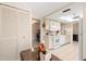 Traditional kitchen with white appliances, neutral cabinets, tile floor and granite countertop at 3626 Medford Ln # 1537, Sarasota, FL 34232