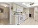Well-lit kitchen equipped with white appliances and ample counter space for meal preparation at 3626 Medford Ln # 1537, Sarasota, FL 34232