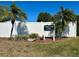Community sign for Village Green, sections 15, 16, and 17, surrounded by landscaping and palm trees at 3626 Medford Ln # 1537, Sarasota, FL 34232