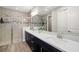 Modern bathroom featuring double sinks, a large mirror, stylish vanity, and a glass-enclosed shower at 3644 Pitch Ln, Sarasota, FL 34232