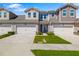 Inviting two-story townhome featuring an attached garage, well-maintained lawn, and a charming front entrance at 3644 Pitch Ln, Sarasota, FL 34232